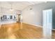 Open-concept living area with wood floors, a ceiling fan, and access to the kitchen at 4844 Booth Bay Dr, New Port Richey, FL 34652