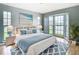 Serene main bedroom featuring a bay window, hardwood floors, and calming blue accents at 4844 Booth Bay Dr, New Port Richey, FL 34652