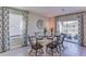 Dining room with white table and black chairs, and access to a patio at 3447 Hilltop Cir, Lakewood Ranch, FL 34211