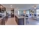 Open kitchen with island, stainless steel appliances, and granite countertops at 3447 Hilltop Cir, Lakewood Ranch, FL 34211