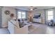 Living Room with white couch, coffee table and large TV at 3447 Hilltop Cir, Lakewood Ranch, FL 34211