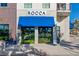Modern commercial building with blue awning, Rocca signage and lush landscaping at 815 W Braddock St, Tampa, FL 33603