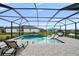 Inviting pool area with covered patio and lounge chairs at 9120 Warm Springs Cir, Parrish, FL 34219