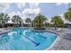 Inviting community pool with lap lanes, a relaxing area, and clubhouse at 9120 Warm Springs Cir, Parrish, FL 34219