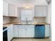 Kitchen with white cabinets, butcher block countertops and blue dishwasher at 1747 Font Ln, Holiday, FL 34691