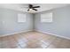 Spacious bedroom with tile floors and ceiling fan at 1747 Font Ln, Holiday, FL 34691