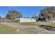 Mobile home with a gravel driveway and fenced backyard at 6343 Angus Valley Dr, Wesley Chapel, FL 33544