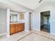 Bathroom with a double vanity and view into another bedroom at 9375 Bearwalk Path, Weeki Wachee, FL 34613