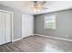 Well-lit bedroom with double closets and wood-look floors at 9375 Bearwalk Path, Weeki Wachee, FL 34613