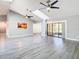 Bright living room with vaulted ceilings, ceiling fans, and luxury vinyl plank flooring at 9375 Bearwalk Path, Weeki Wachee, FL 34613