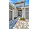 Front entry with double doors and a paved walkway at 10661 Torchwood Sea Way, San Antonio, FL 33576