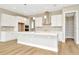 Modern kitchen with white cabinets, quartz countertops and a walk-in pantry at 10661 Torchwood Sea Way, San Antonio, FL 33576