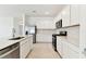 Modern kitchen with stainless steel appliances and white cabinets at 20723 Balsam Hill Rd, Land O Lakes, FL 34638