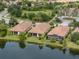 Aerial view of lovely homes with lush landscaping, lawn and water view at 5243 Esplanade Blvd, Bradenton, FL 34211