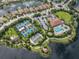 Aerial photograph displaying community amenities featuring tennis courts, a clubhouse, and a pool for recreational enjoyment at 5243 Esplanade Blvd, Bradenton, FL 34211