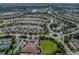 Stunning aerial view showcasing a community with lakeside homes, lush landscaping, and a network of winding roads at 5243 Esplanade Blvd, Bradenton, FL 34211