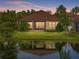 Charming home with lush yard, landscaping and water view at sunset at 5243 Esplanade Blvd, Bradenton, FL 34211