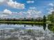 Serene backyard featuring a tranquil lake view, enhancing the property's appeal with a sense of calm and natural beauty at 5243 Esplanade Blvd, Bradenton, FL 34211