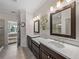 Bright bathroom featuring dual sinks with dark wood cabinets and quartz countertops at 5243 Esplanade Blvd, Bradenton, FL 34211