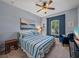 Comfortable bedroom with blue and white bedding, a ceiling fan, and an accent wall at 5243 Esplanade Blvd, Bradenton, FL 34211