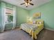Inviting bedroom painted mint-green featuring a ceiling fan, and natural light at 5243 Esplanade Blvd, Bradenton, FL 34211
