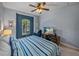 Comfortable bedroom with blue and white bedding, a ceiling fan, and a TV at 5243 Esplanade Blvd, Bradenton, FL 34211