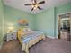 Cozy bedroom with a ceiling fan, neutral carpet, and light green walls at 5243 Esplanade Blvd, Bradenton, FL 34211