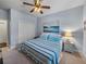 Comfortable bedroom with blue and white bedding, a ceiling fan and carpet floors at 5243 Esplanade Blvd, Bradenton, FL 34211