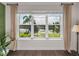 Bedroom window showcasing serene water view with palm trees, pond, and natural lighting at 5243 Esplanade Blvd, Bradenton, FL 34211