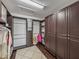 Walk-in closet with custom shelving and dark wood floor at 5243 Esplanade Blvd, Bradenton, FL 34211