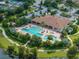 Aerial photo showcasing an attractive community pool with ample seating, surrounded by lush landscaping for a resort-like experience at 5243 Esplanade Blvd, Bradenton, FL 34211