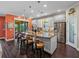 Modern kitchen featuring a granite island with seating, stainless steel appliances, and sliding glass doors at 5243 Esplanade Blvd, Bradenton, FL 34211