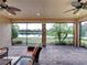 Relaxing screened lanai with brick flooring and tranquil water view with ceiling fans at 5243 Esplanade Blvd, Bradenton, FL 34211