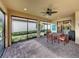 Beautiful outdoor lanai featuring a dining table, screened windows and green landscaping at 5243 Esplanade Blvd, Bradenton, FL 34211