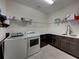Well-equipped laundry room with modern washer, dryer, sink, and ample storage, offering convenience and functionality at 5243 Esplanade Blvd, Bradenton, FL 34211