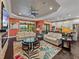 Bright and airy living space with seating, kitchen with granite island, and views of the lush backyard at 5243 Esplanade Blvd, Bradenton, FL 34211