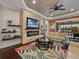 Inviting living room boasts stone fireplace, floating shelves, and sliding glass doors leading to an outdoor space at 5243 Esplanade Blvd, Bradenton, FL 34211