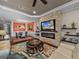Open-concept living room with a stone fireplace feature and views to the dining and kitchen areas at 5243 Esplanade Blvd, Bradenton, FL 34211