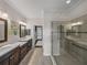 Main bathroom features dual sinks, walk-in shower with tile surround, and a walk-in closet at 5243 Esplanade Blvd, Bradenton, FL 34211