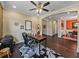 Bright home office featuring hardwood floors, ceiling fan, desk, and an adjacent sitting area at 5243 Esplanade Blvd, Bradenton, FL 34211