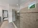 Tiled shower featuring glass door and window at 5243 Esplanade Blvd, Bradenton, FL 34211