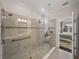 Bright tiled shower featuring glass door and window at 5243 Esplanade Blvd, Bradenton, FL 34211