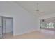 Open living area with tile floors and access to sunroom at 902 Mcdaniel St # 1, Sun City Center, FL 33573