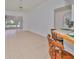 Bright living room with tile floors and view into spacious sunroom at 902 Mcdaniel St # 1, Sun City Center, FL 33573