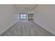 Primary bedroom with carpeted floor, ceiling fan and access to patio at 902 Mcdaniel St # 1, Sun City Center, FL 33573