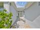 Front entry with a stone paved walkway and screened door at 902 Mcdaniel St # 1, Sun City Center, FL 33573