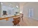 Kitchen features a breakfast bar with two stools and white cabinetry at 902 Mcdaniel St # 1, Sun City Center, FL 33573