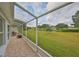 Screened patio with paver stone floor and view of the backyard at 902 Mcdaniel St # 1, Sun City Center, FL 33573