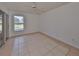 Bright bedroom with tile floors, sliding glass door, and ceiling fan at 902 Mcdaniel St # 1, Sun City Center, FL 33573