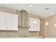 Sleek kitchen with stainless steel range hood and glass pendant lighting at 10520 Purple Thistle Way, San Antonio, FL 33576